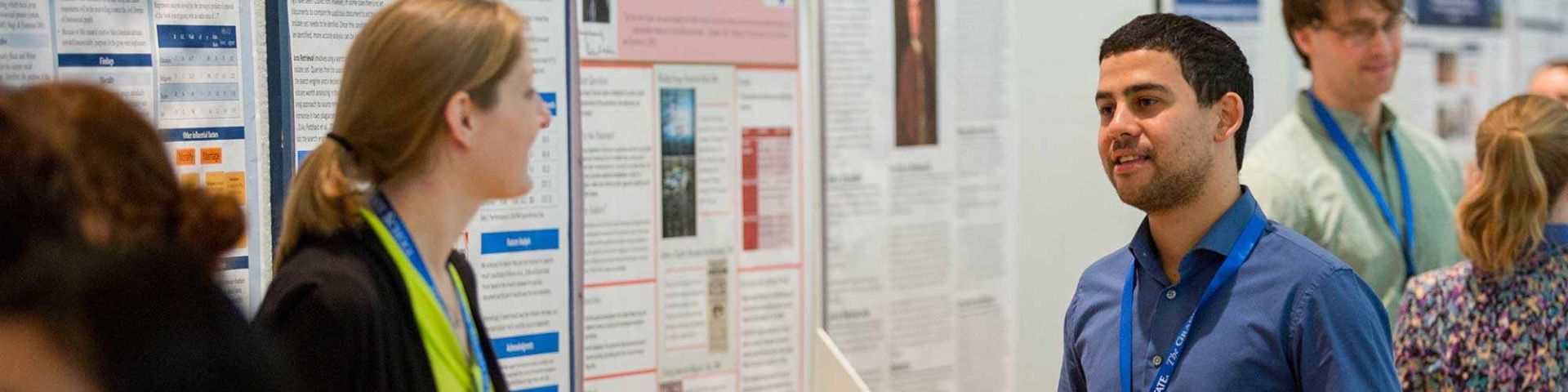 PhD candidate speaking at a poster session