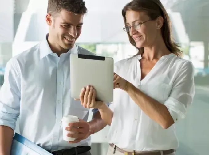 IT professionals consulting while looking at a tablet.