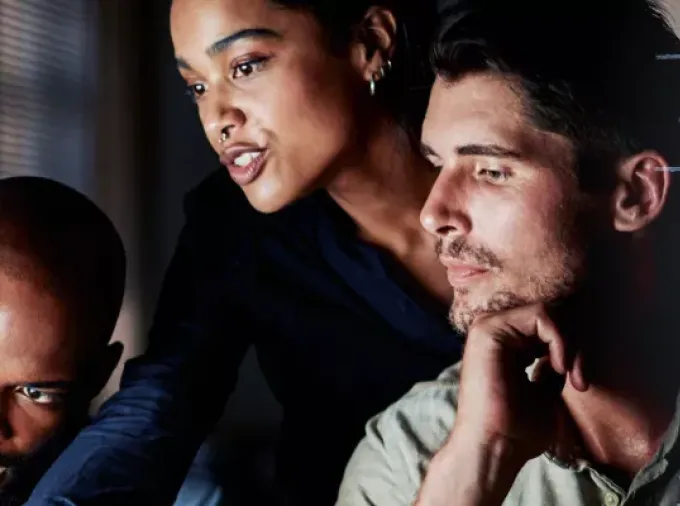 IT professionals working together to review analytics.