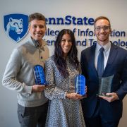 Alumni award recipients pose with their awards.