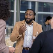 An alumnus speaks at a social event.