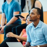 Adult student learning in graduate school lecture.