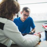 Instructor correcting student paper