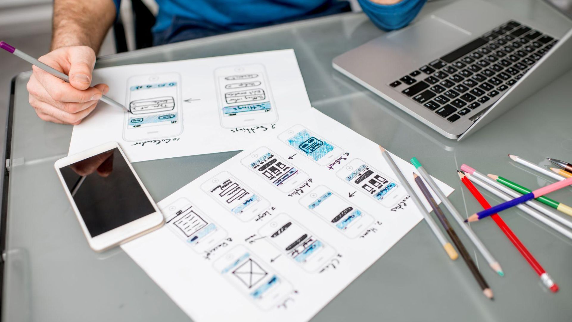 A closeup of someone wireframing a mobile application design.