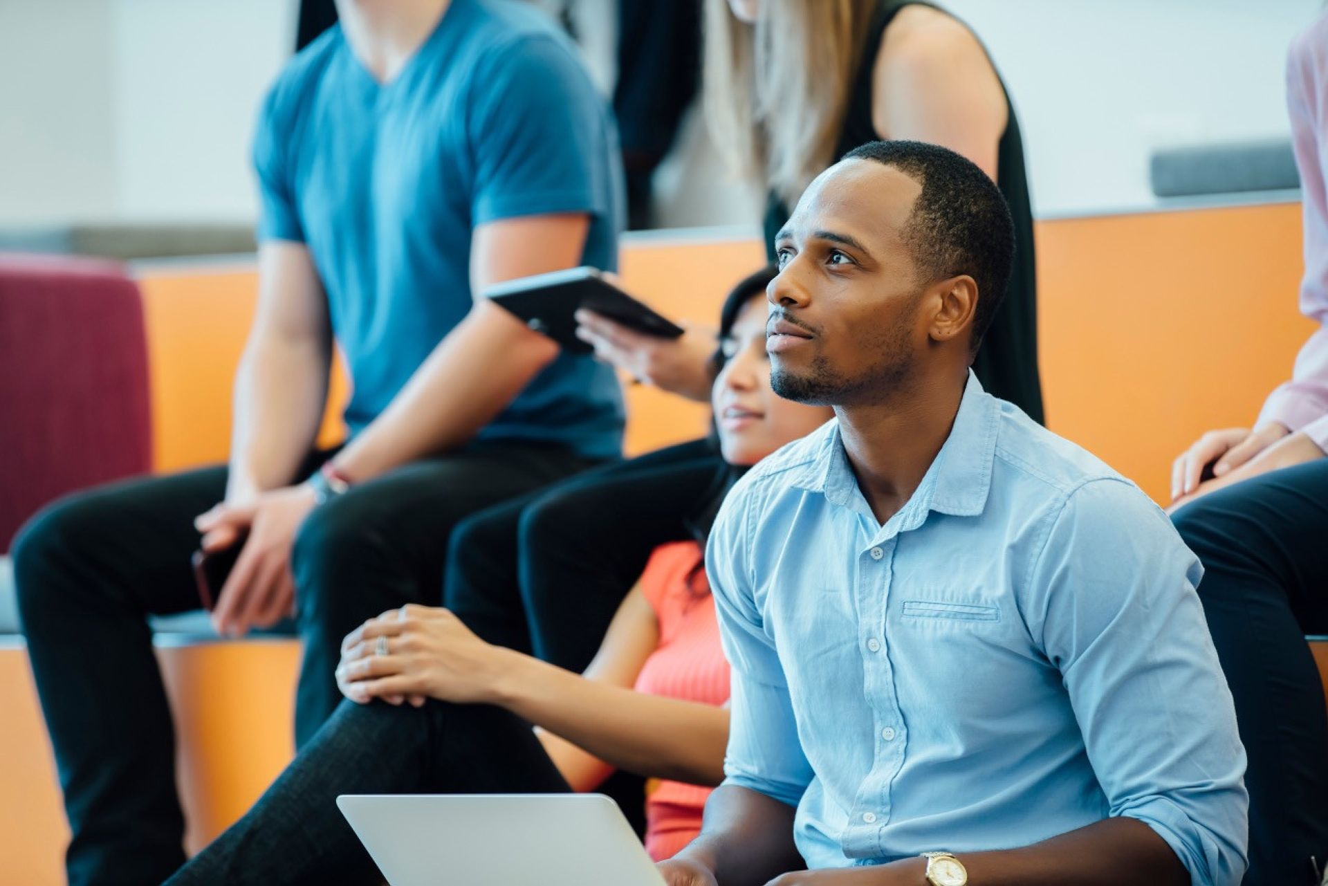 Adult student learning in graduate school lecture.