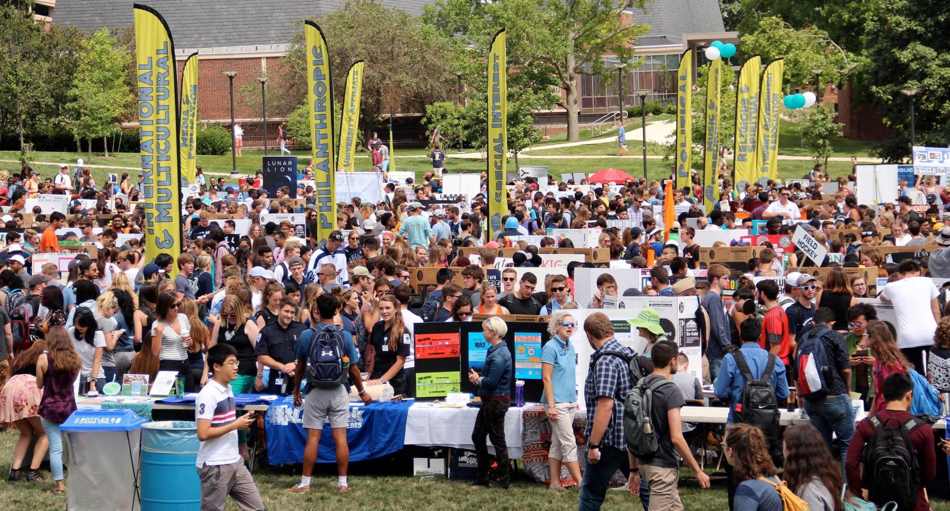 Large group of students attending student engagement fair outdoors.