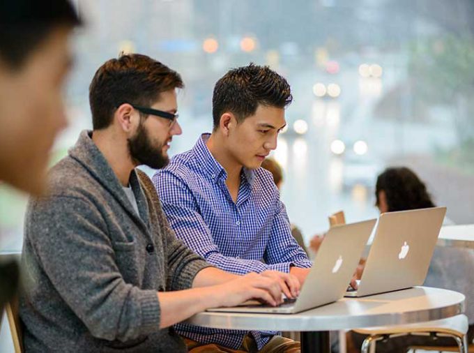 Pair of students using laptop computers