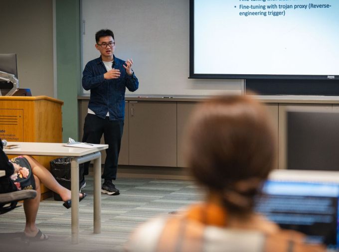 A faculty member presents his research.