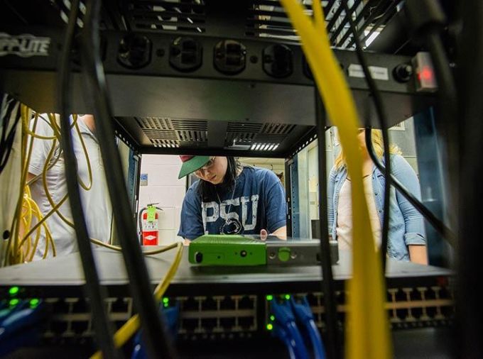 Student working in a networking closet