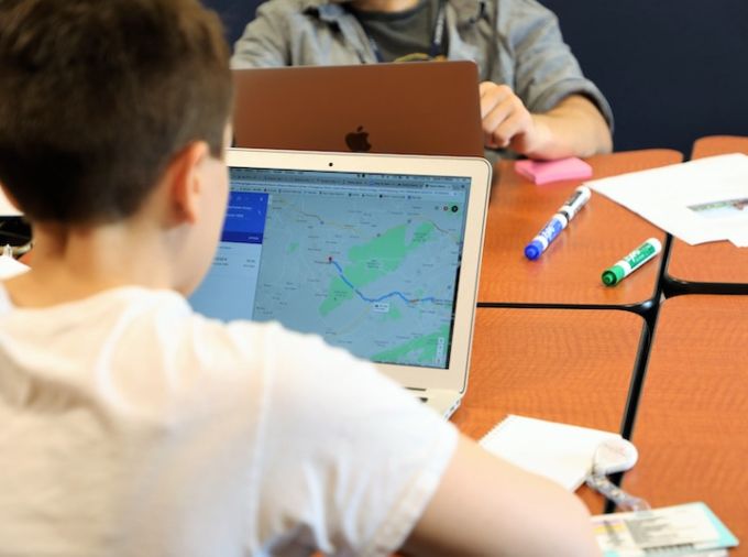 student using google maps on his laptop
