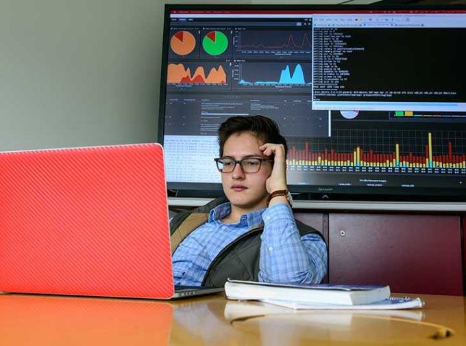 Student reading from laptop computer