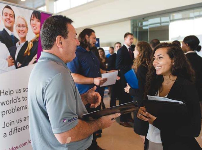 Young woman talking to older gentleman