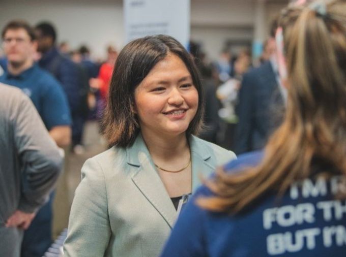 A student talks to a recruiter at a career fair.