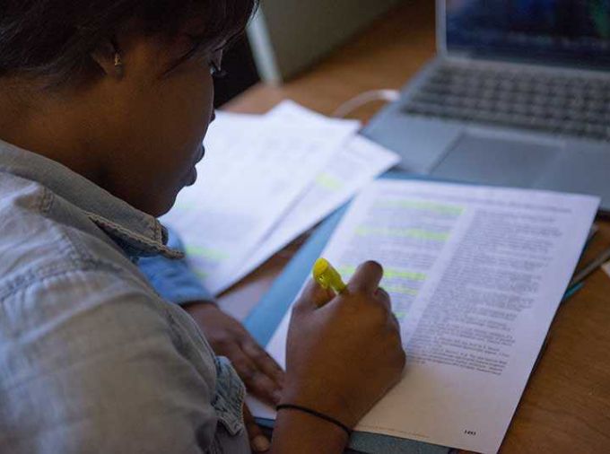 Teaching Assistant highlighting a student paper