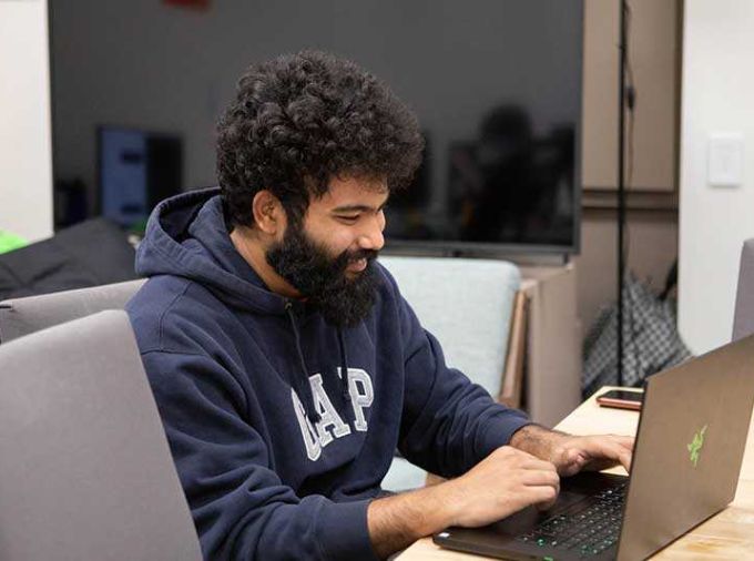 Graduate student working on a laptop.