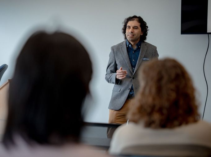 A faculty member teaching in a classroom.