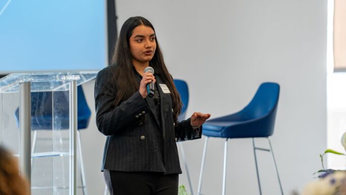 A student in a suite speaks into a microphone.
