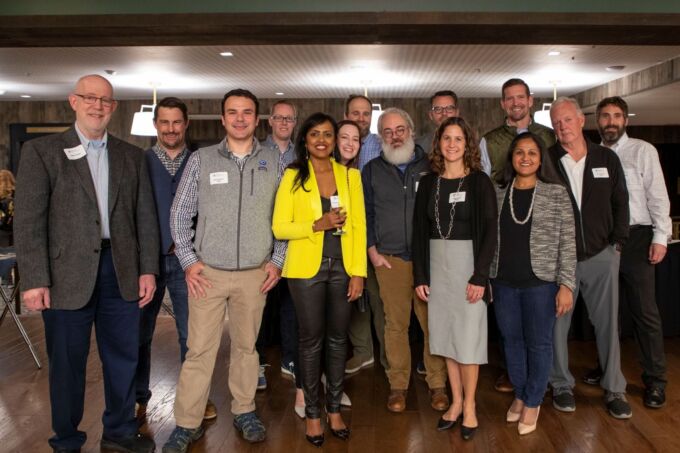 A group of alumni pose for a photo.