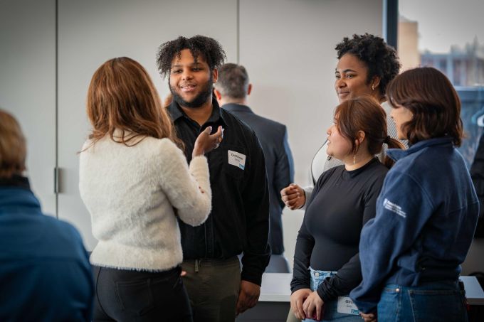 A student smiles during a conversation.
