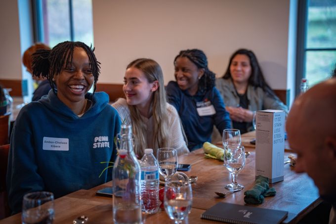 Students laugh at a table.