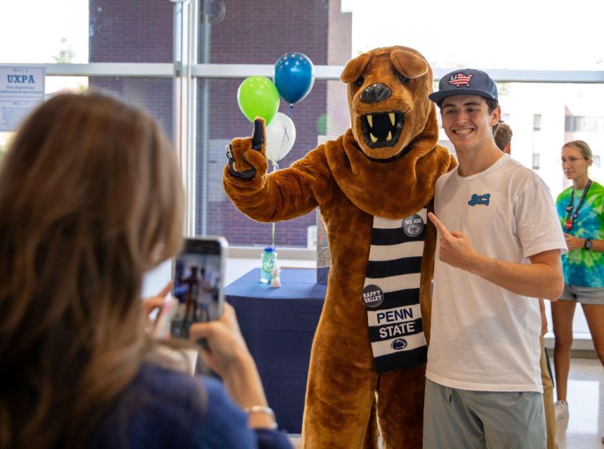 A student gets a photo with the Nittany Lion mascot.