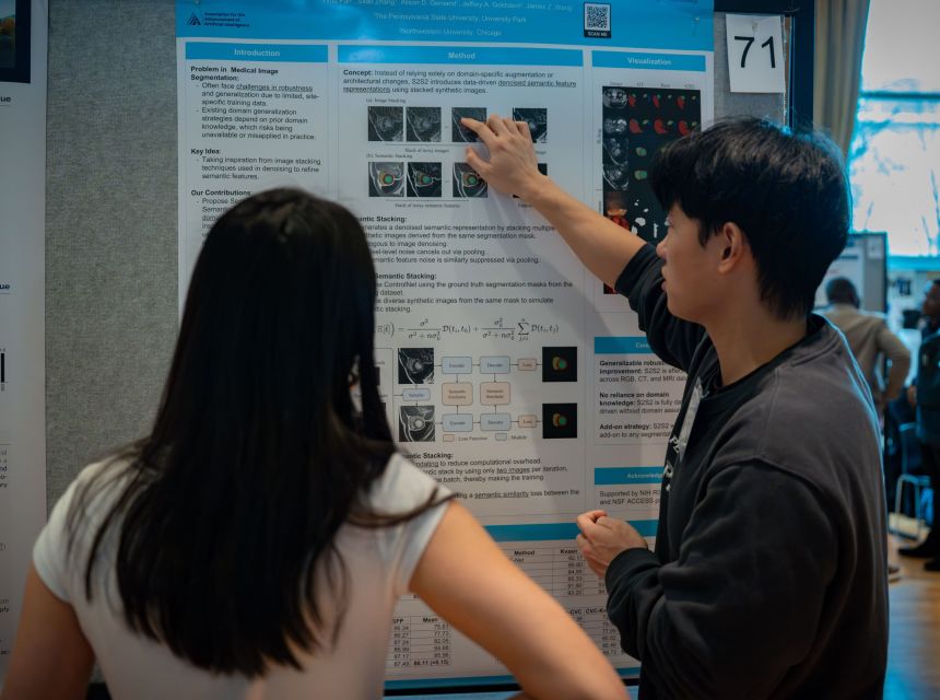 A graduate student showcasing his research on a poster.