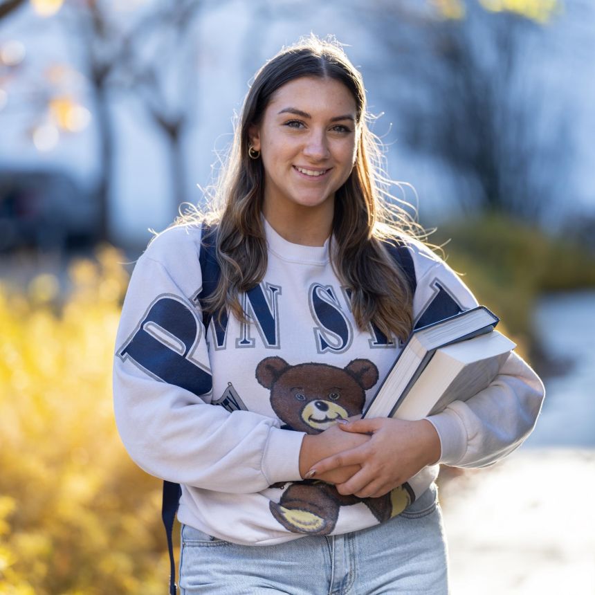 Photo of a student holding books