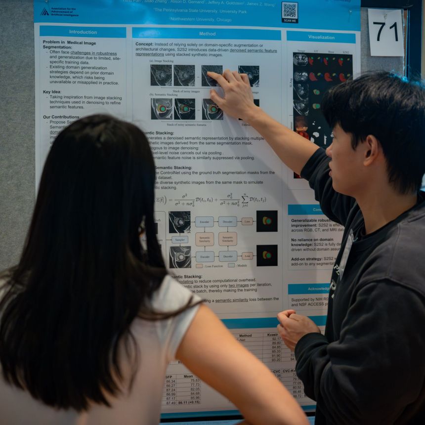 A graduate student showcasing his research on a poster.
