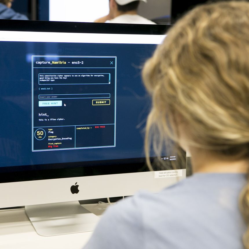 A student participates in a capture the flag cybersecurity exercise on a computer.