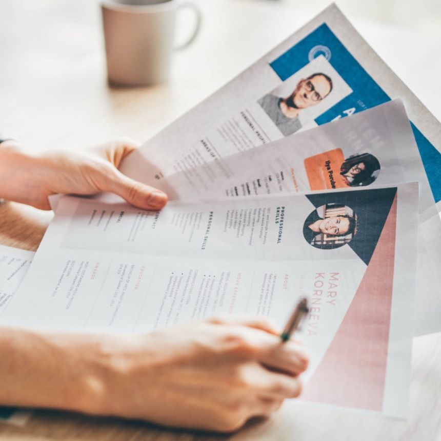 Manager looking at many different resumes.