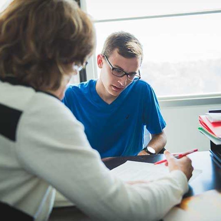 Instructor correcting student paper